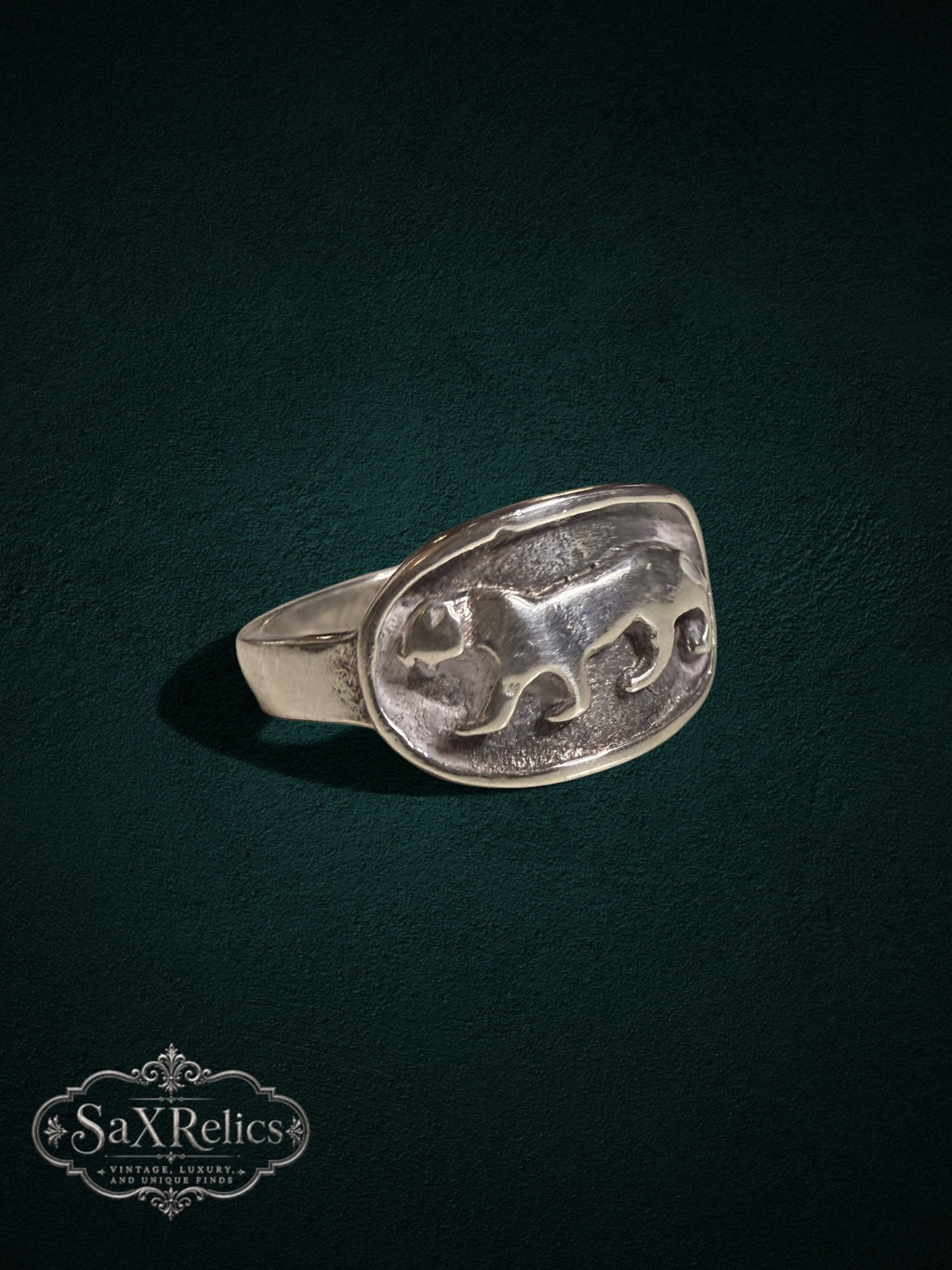 SaX Relics sterling silver signet ring featuring a detailed prowling big cat relief on an oval face.
