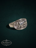 SaX Relics sterling silver signet ring featuring a detailed prowling big cat relief on an oval face.
