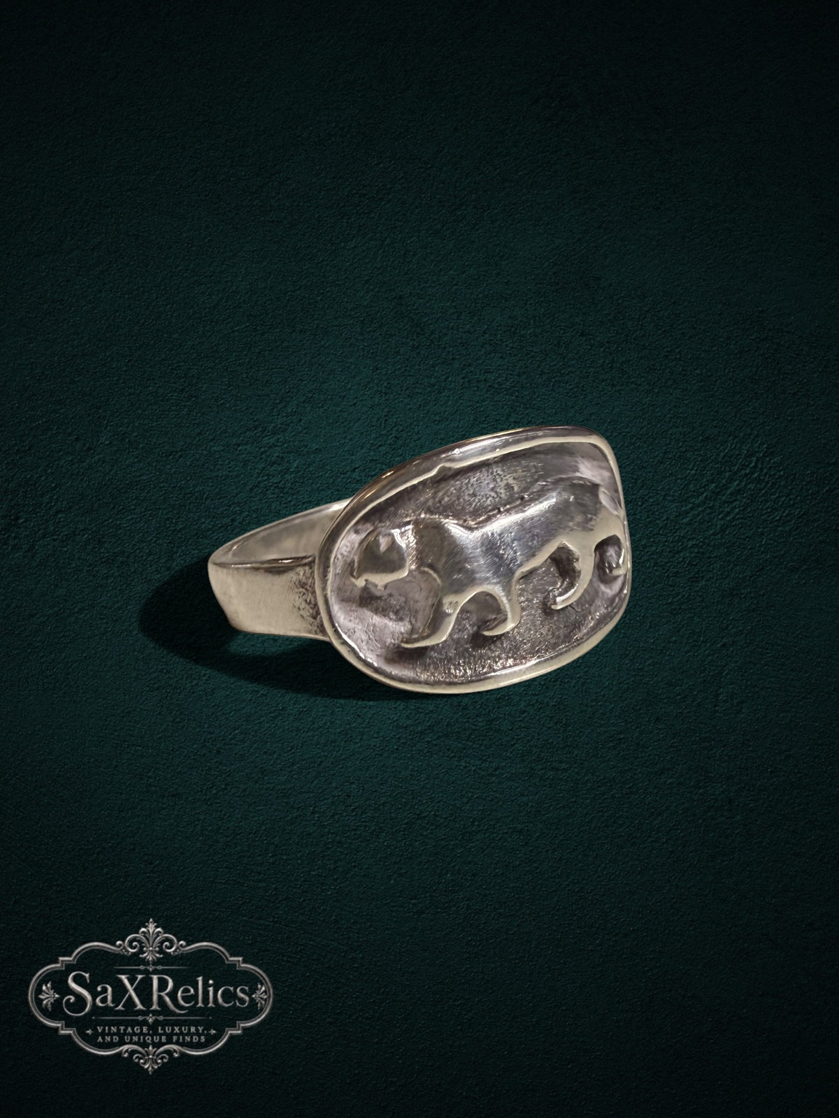 SaX Relics sterling silver signet ring featuring a detailed prowling big cat relief on an oval face.
