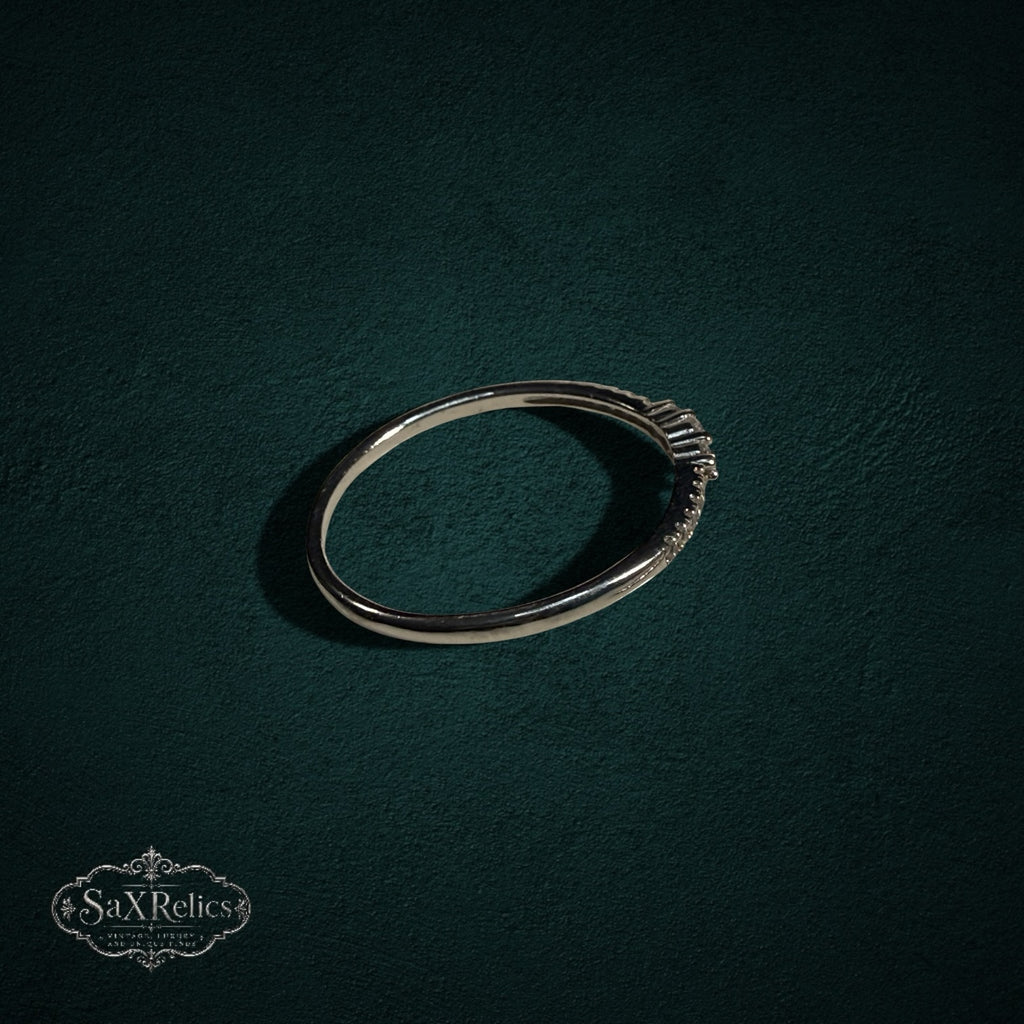 My Store delicate 925 sterling silver band ring with shimmering clear stones on a dark green textured background