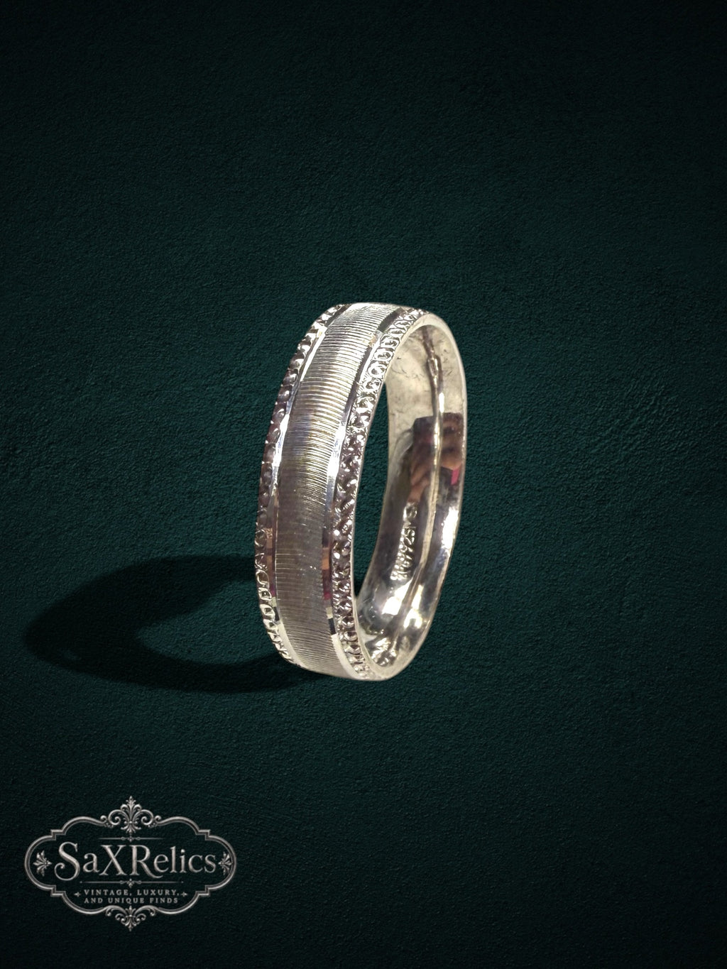 My Store sterling silver band ring with a brushed center and ornate decorative edges in a vintage-inspired style.