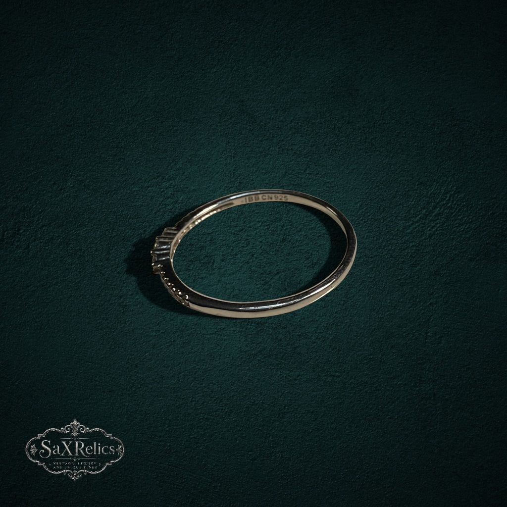 My Store delicate 925 sterling silver band ring with shimmering clear stones on a dark green textured background