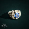 My Store SAXRelics sterling silver statement ring with a deep blue oval gemstone and intricate rope-style detailing.