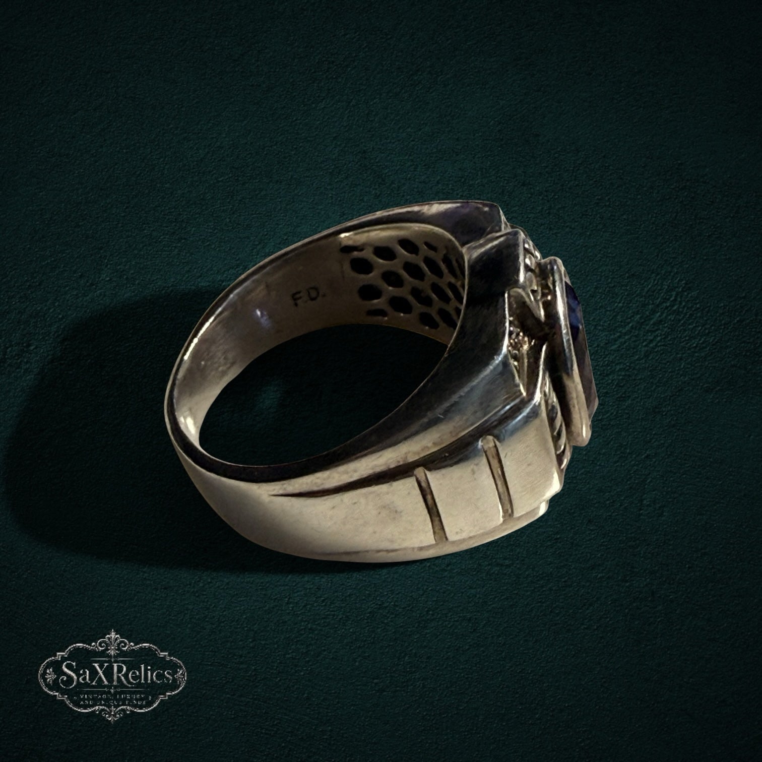 My Store SAXRelics sterling silver statement ring with a deep blue oval gemstone and intricate geometric band detailing.