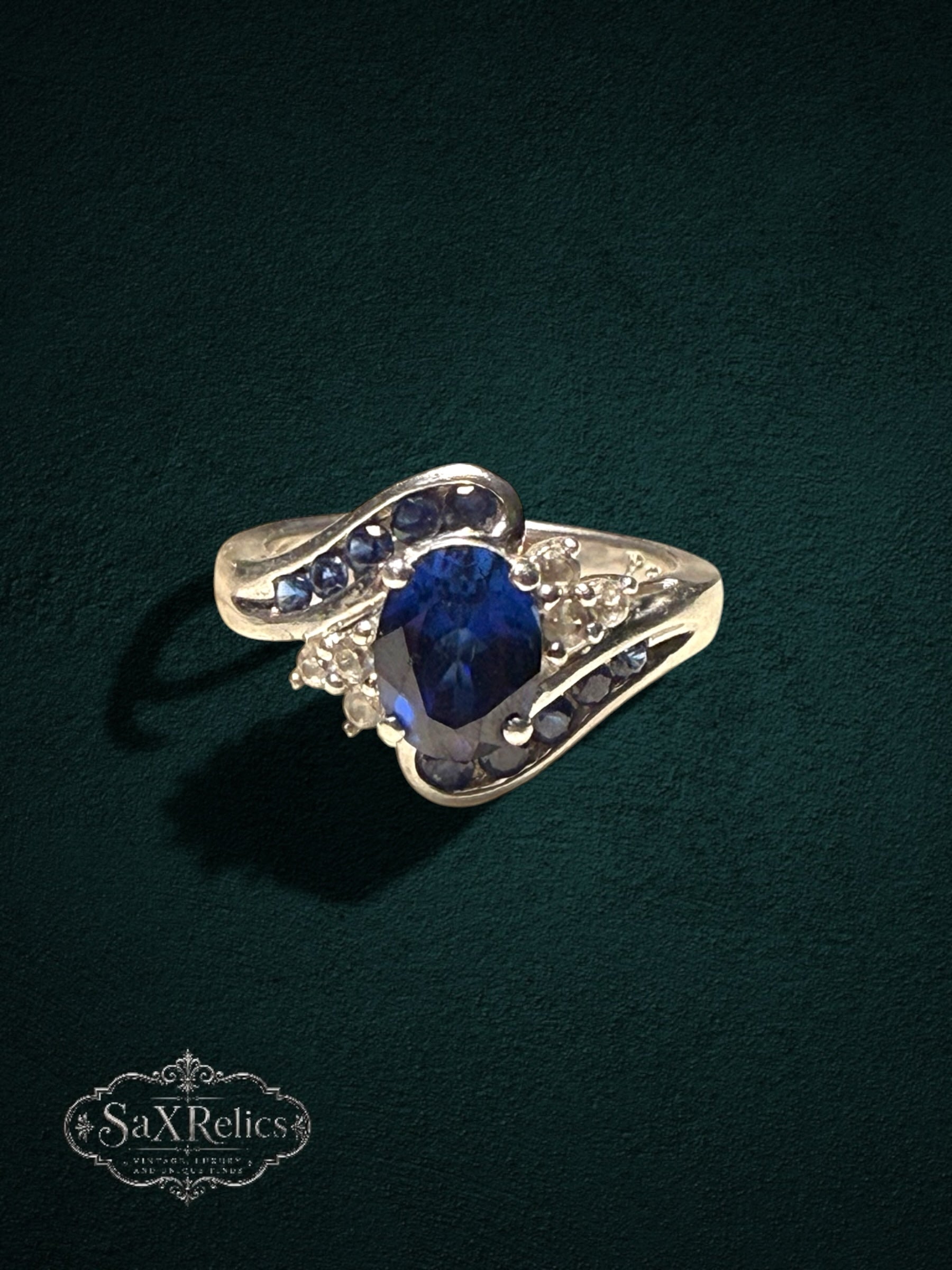 My Store sterling silver statement ring featuring an oval deep blue center stone with blue and clear crystal accents.