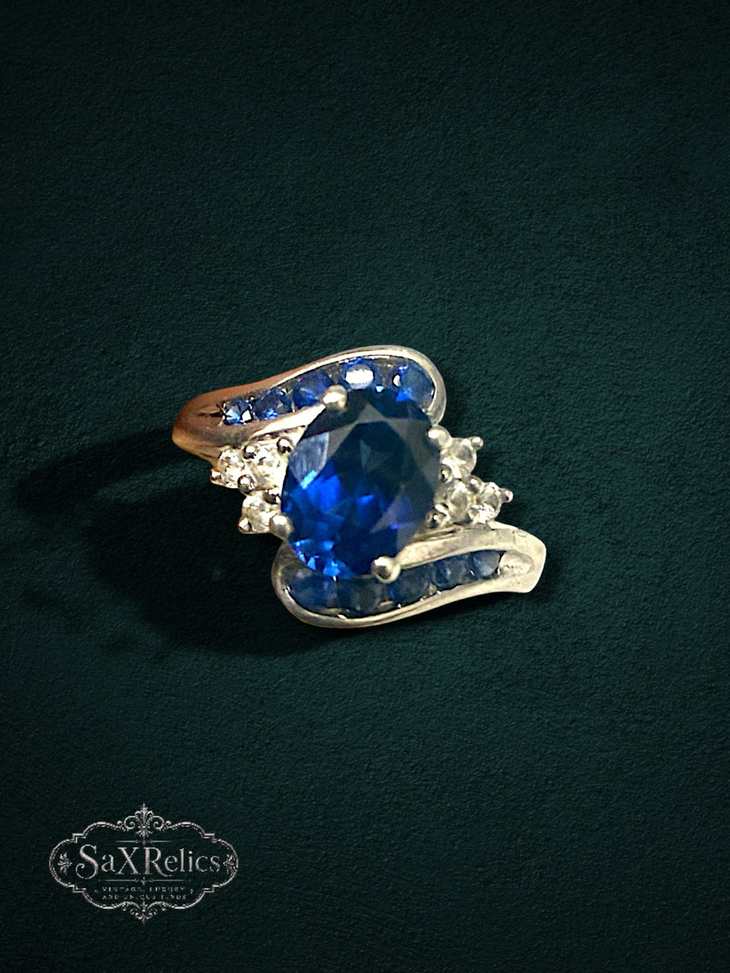 My Store sterling silver statement ring featuring a large oval deep blue center stone with blue and clear crystal accents.