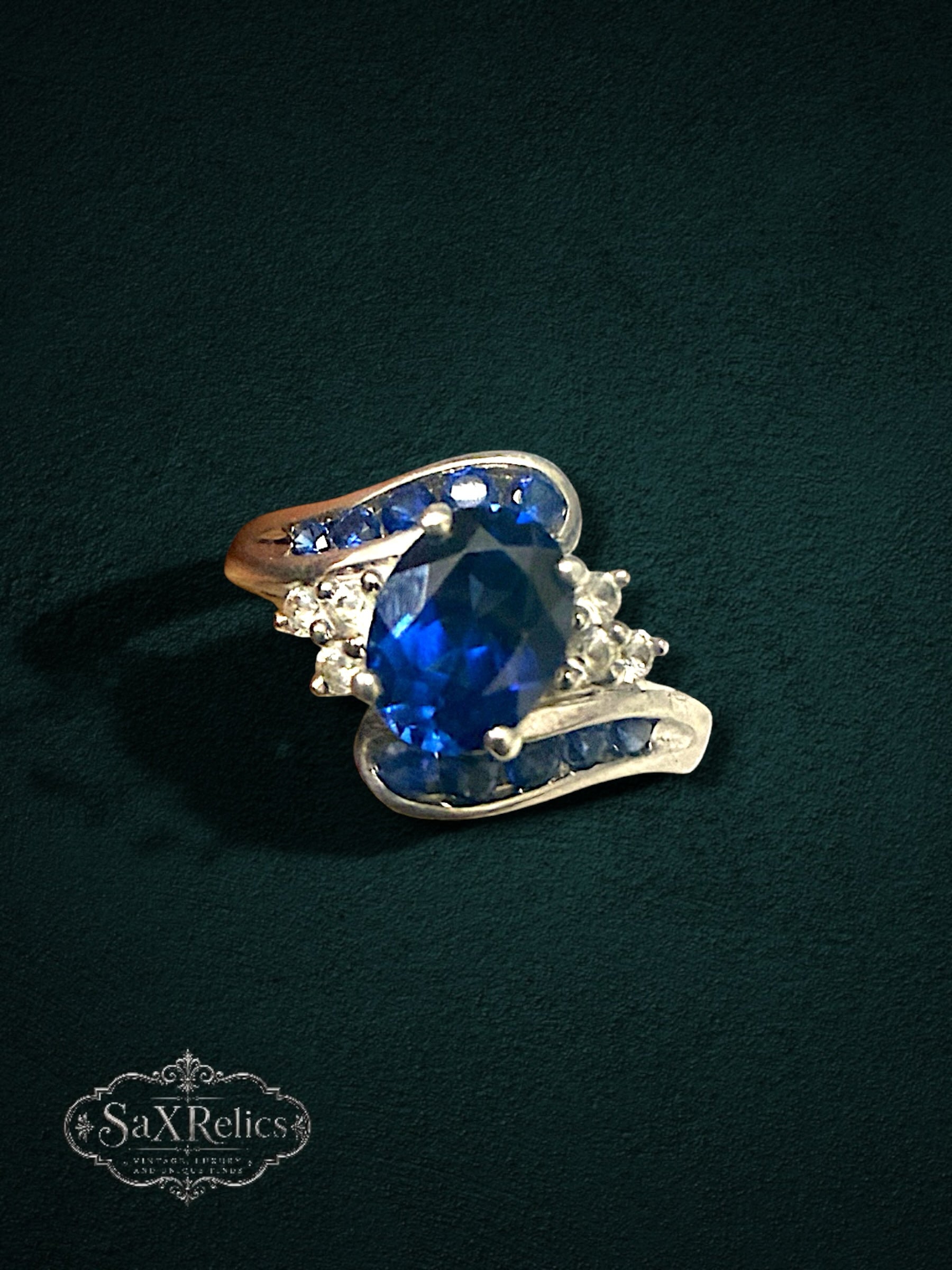 My Store sterling silver statement ring featuring a large oval deep blue center stone with blue and clear crystal accents.