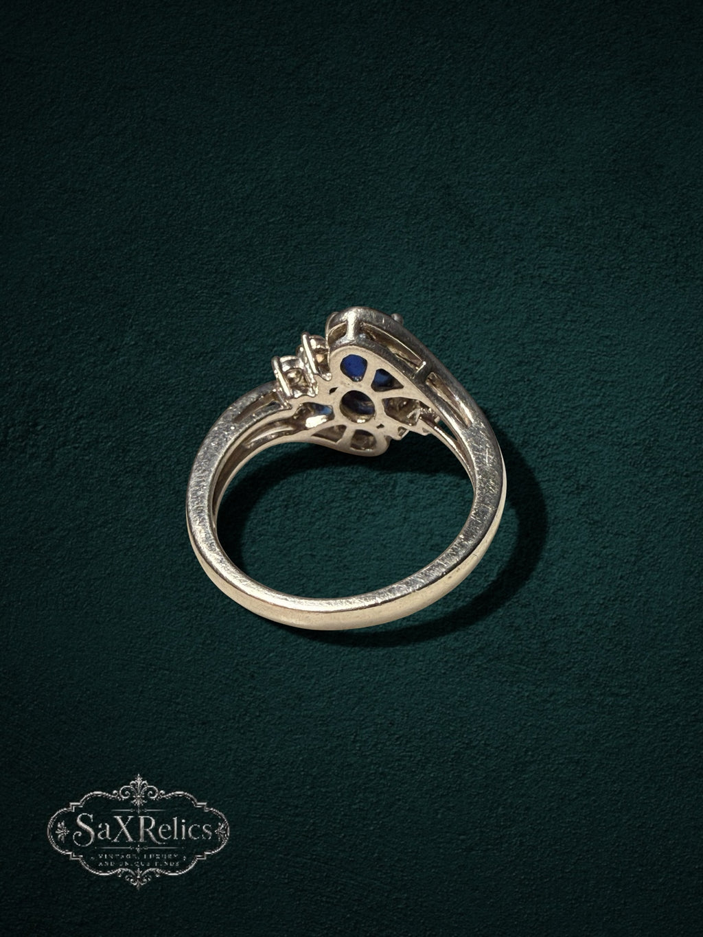 My Store sterling silver statement ring with a deep blue oval center stone and clear crystal accents on a dark background