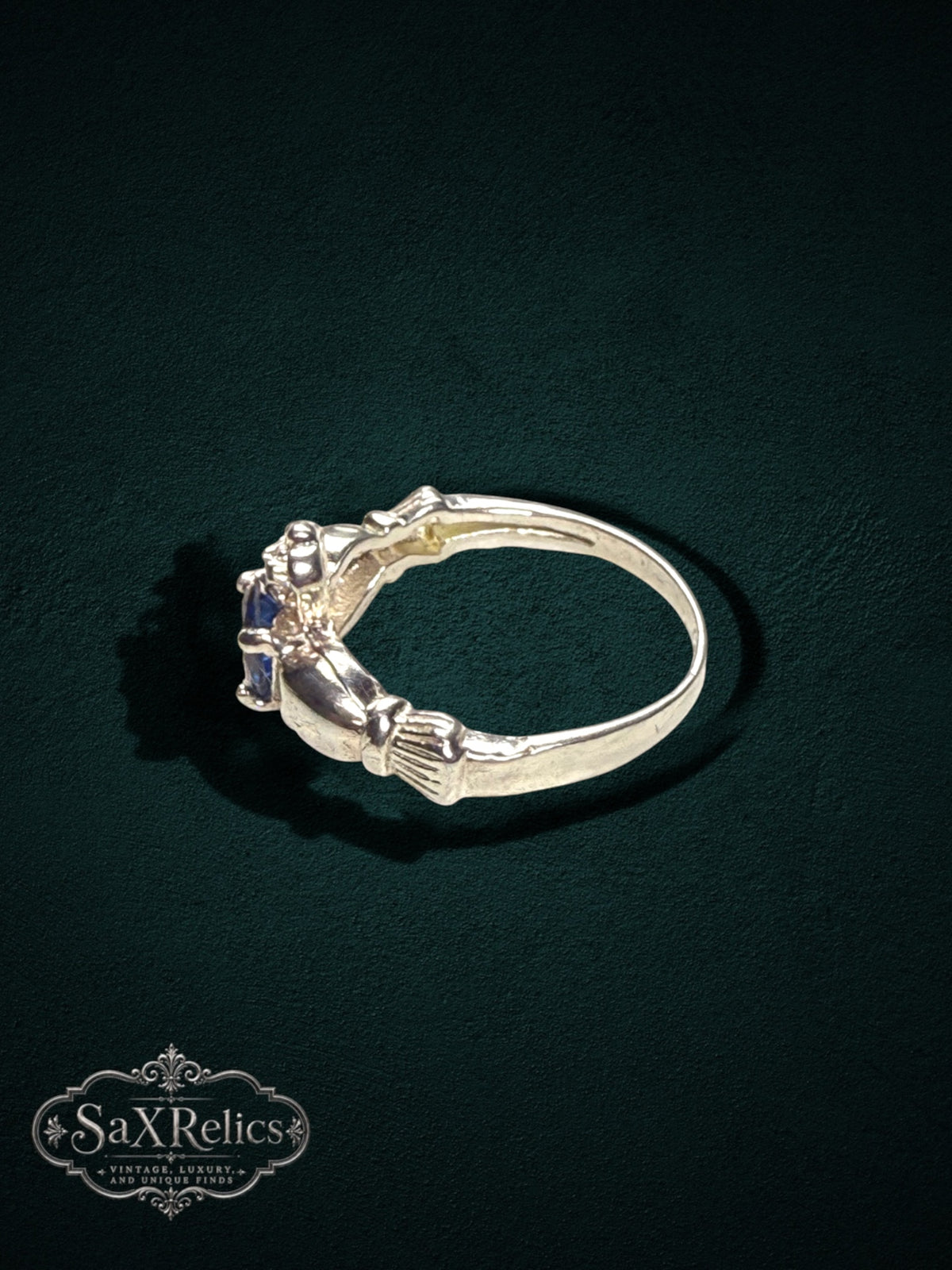 My Store SAXRelics sterling silver Claddagh ring featuring a deep blue center stone and traditional heart motif.