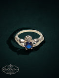 My Store SAXRelics sterling silver Claddagh ring featuring a vibrant blue center stone and iconic heart motif.