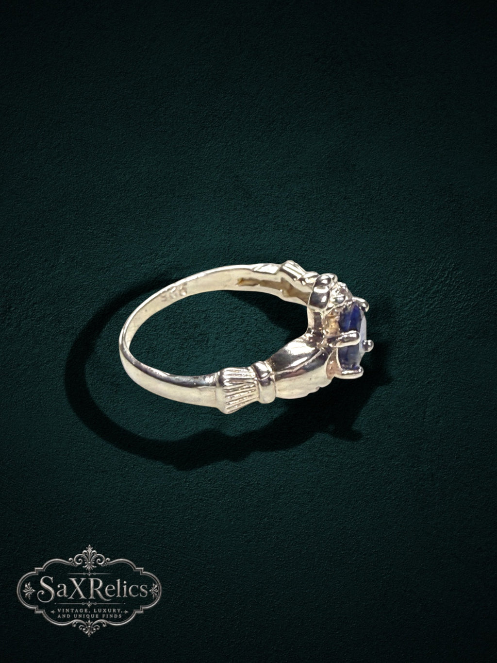 My Store SAXRelics sterling silver Claddagh ring featuring a deep blue center stone and iconic heart and crown motif.