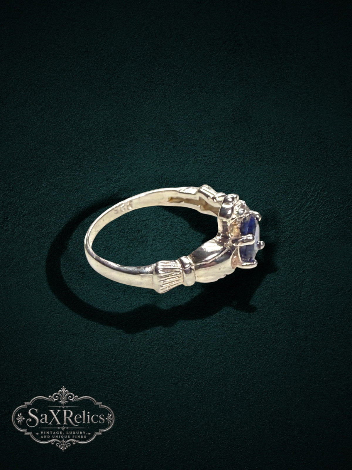 My Store SAXRelics sterling silver Claddagh ring featuring a deep blue center stone and iconic heart and crown motif.