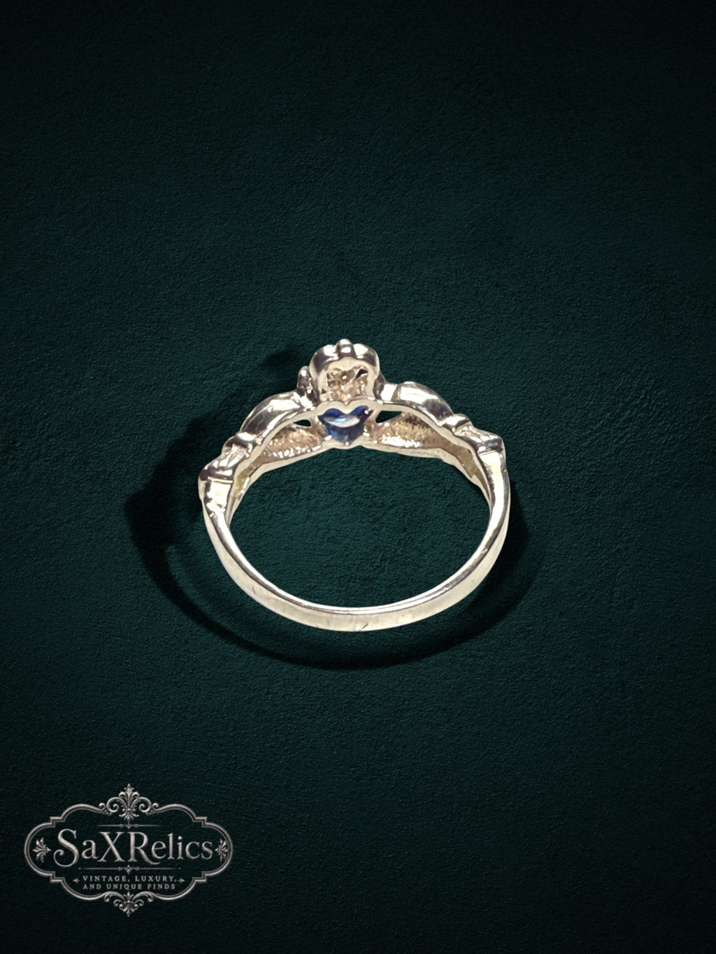 My Store SAXRelics sterling silver Claddagh ring featuring a heart, hands, and crown motif with a blue center stone.