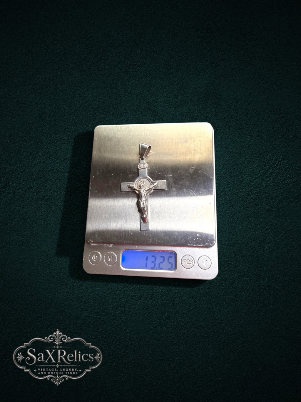 My Store 925 sterling silver crucifix pendant with Saint Benedict medal on a digital scale showing 13.25 grams