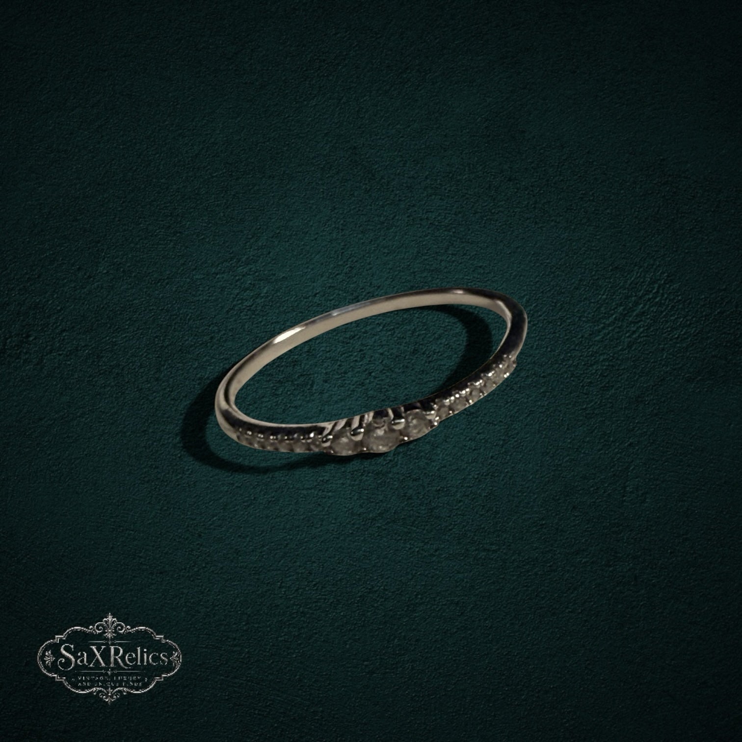 My Store delicate 925 sterling silver band ring with shimmering clear stones on a dark textured background