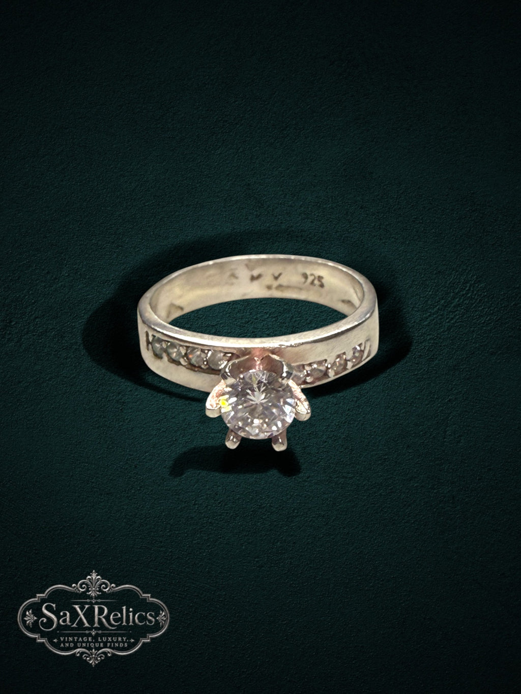 My Store 925 sterling silver engagement ring with a brilliant center stone and channel-set accent stones