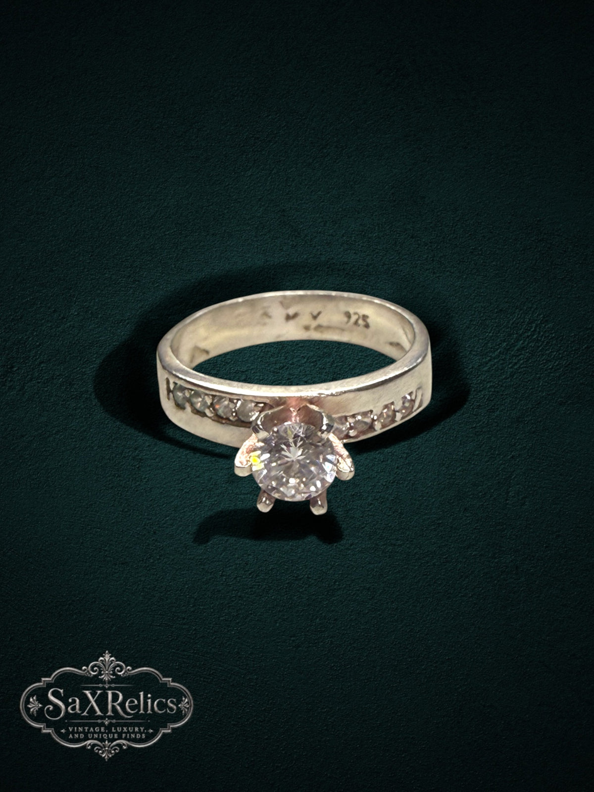 My Store 925 sterling silver engagement ring with a brilliant center stone and channel-set accent stones