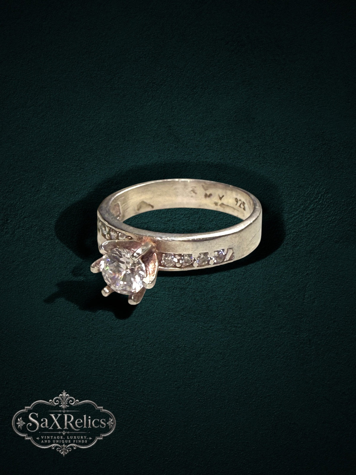 My Store sterling silver engagement ring with a prong-set center stone and channel-set accent stones on the band.