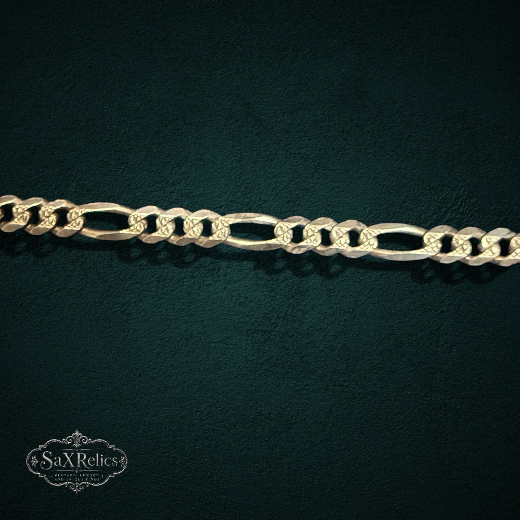 My Store 925 sterling silver Figaro chain bracelet with alternating circular and elongated oval links on dark background