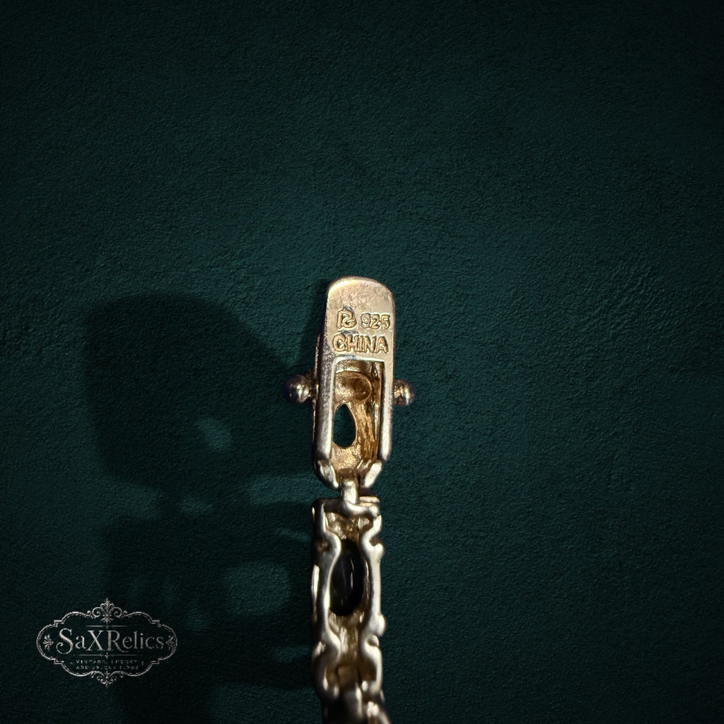 My Store 925 sterling silver Figaro chain bracelet clasp with hallmark detail on a dark green background