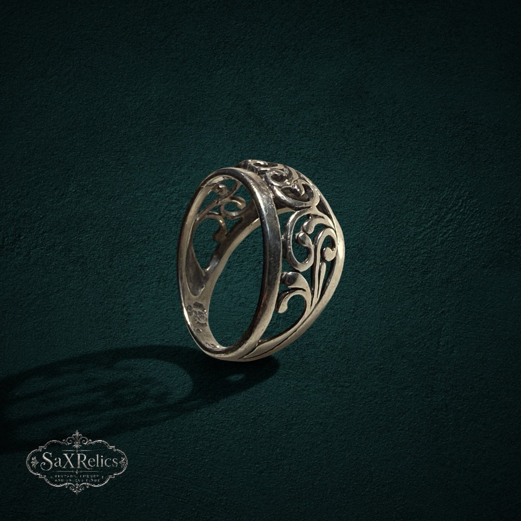 My Store SAXRelics sterling silver ring featuring intricate ornate filigree scrollwork on a dark textured background.