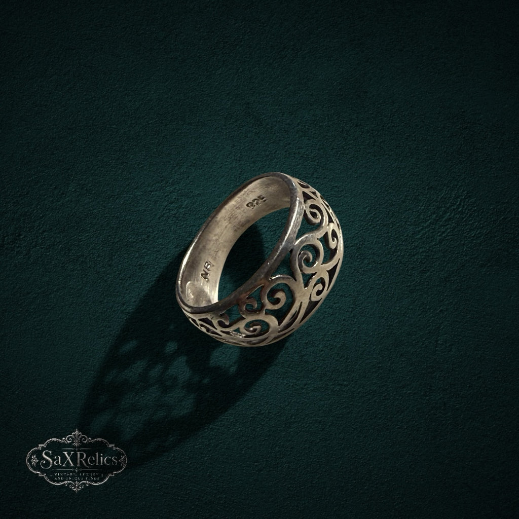 My Store sterling silver band ring featuring an intricate vintage-inspired filigree scrollwork design on a dark background