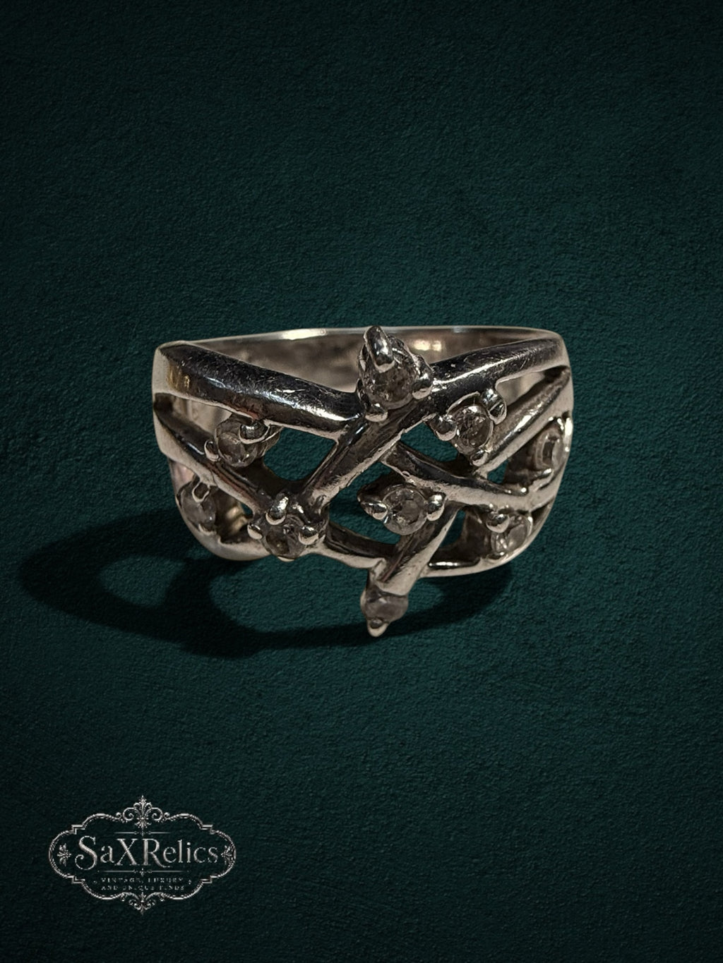 My Store SAXRelics sterling silver statement ring with intricate filigree vine design and clear stone accents.