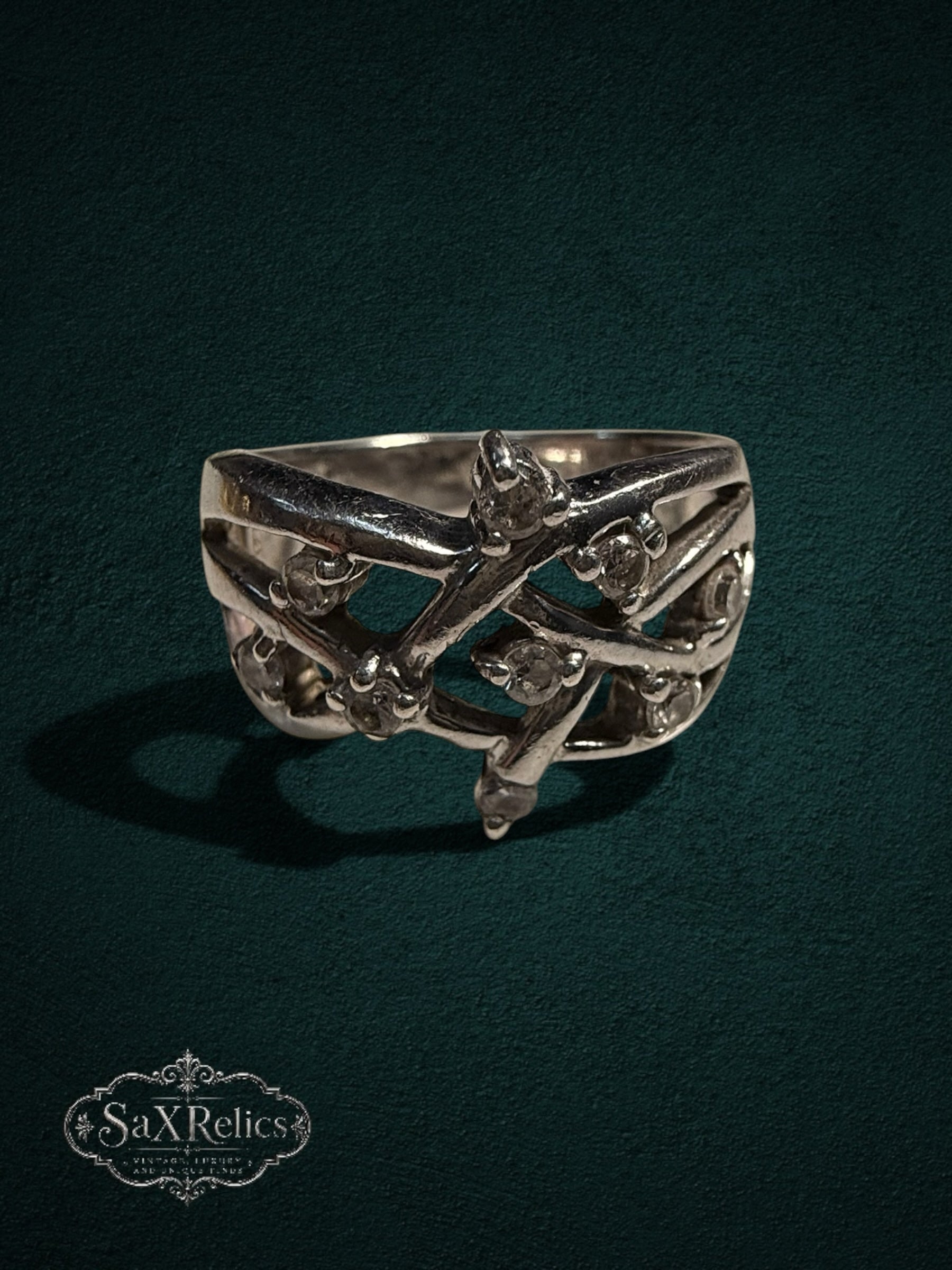 My Store SAXRelics sterling silver statement ring with intricate filigree vine design and clear stone accents.