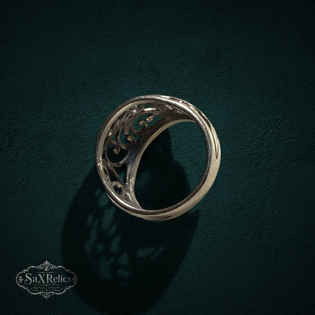 My Store SAXRelics sterling silver ring featuring intricate vintage-inspired filigree scrollwork on a dark background.