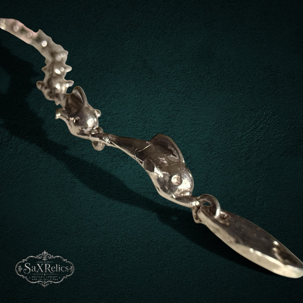 SaX Relics — Delfines sterling silver bracelet, close view of the articulated leaping dolphin links.