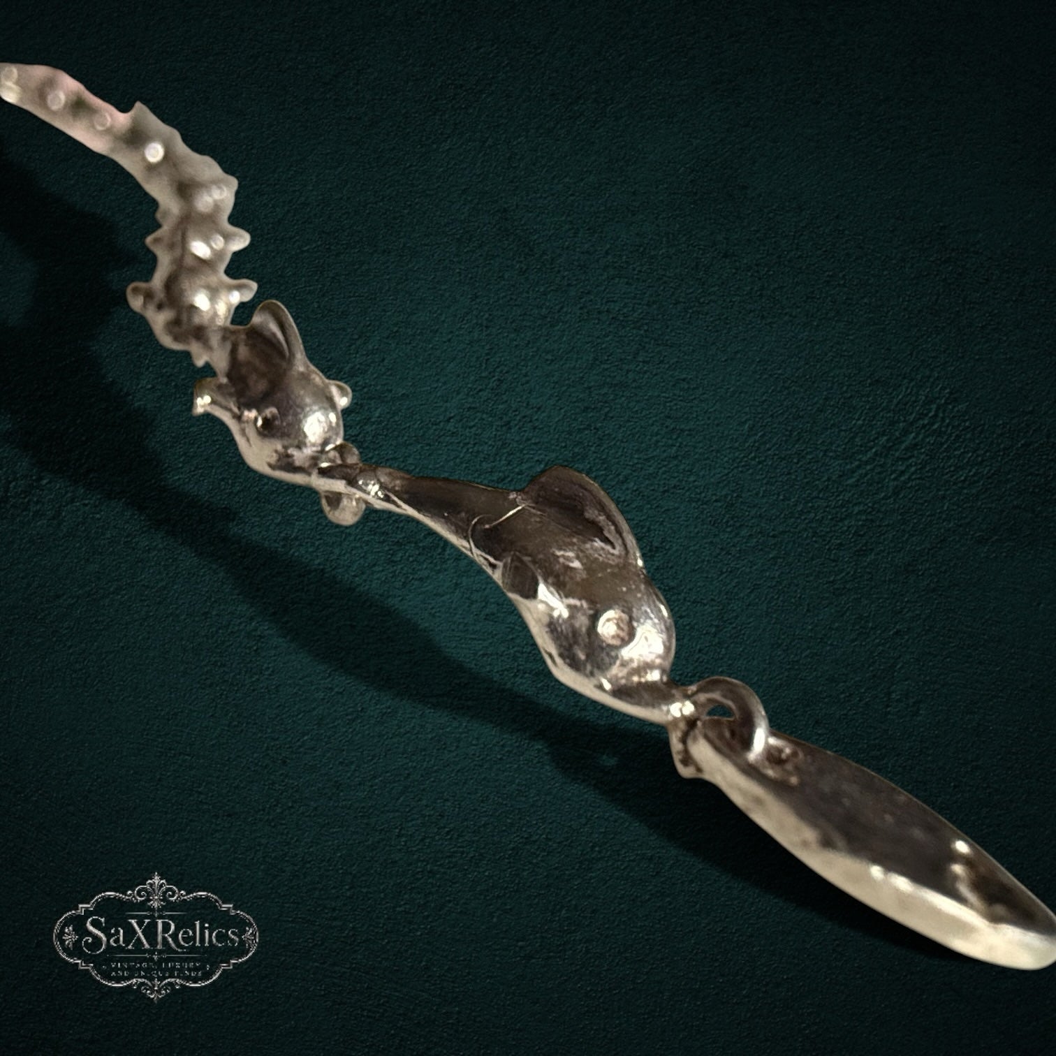 SaX Relics — Delfines sterling silver bracelet, close view of the articulated leaping dolphin links.