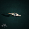My Store sterling silver ring with a central oval gemstone, baguette accents, and round stones on a dark background.