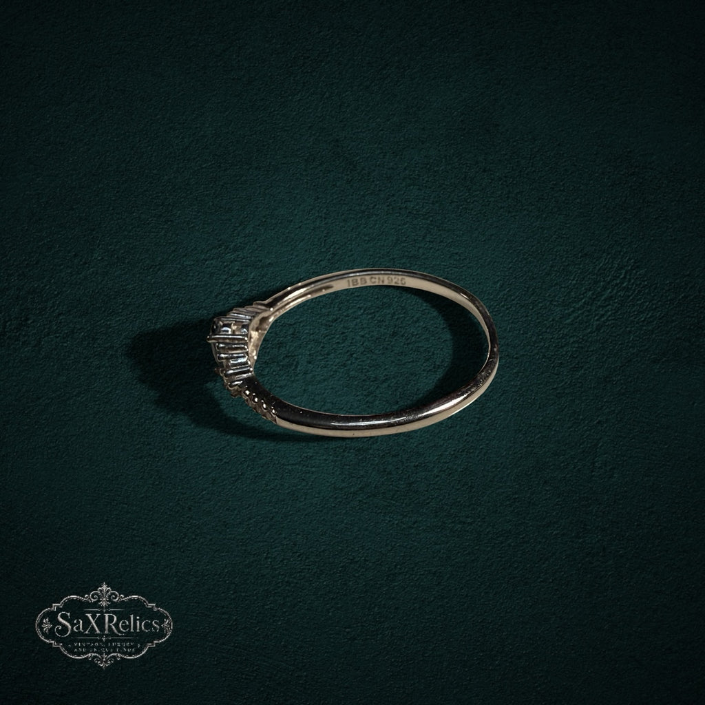 My Store 925 sterling silver ring with oval and baguette-cut gemstones on a dark green textured background