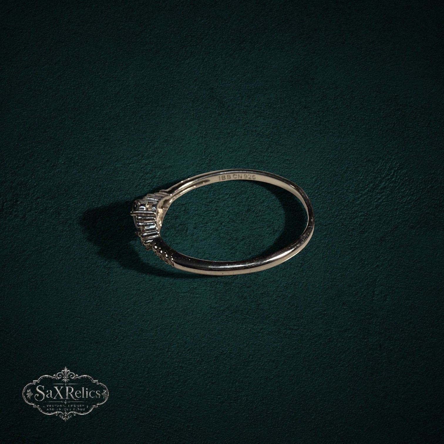My Store 925 sterling silver ring with oval and baguette-cut gemstones on a dark green textured background