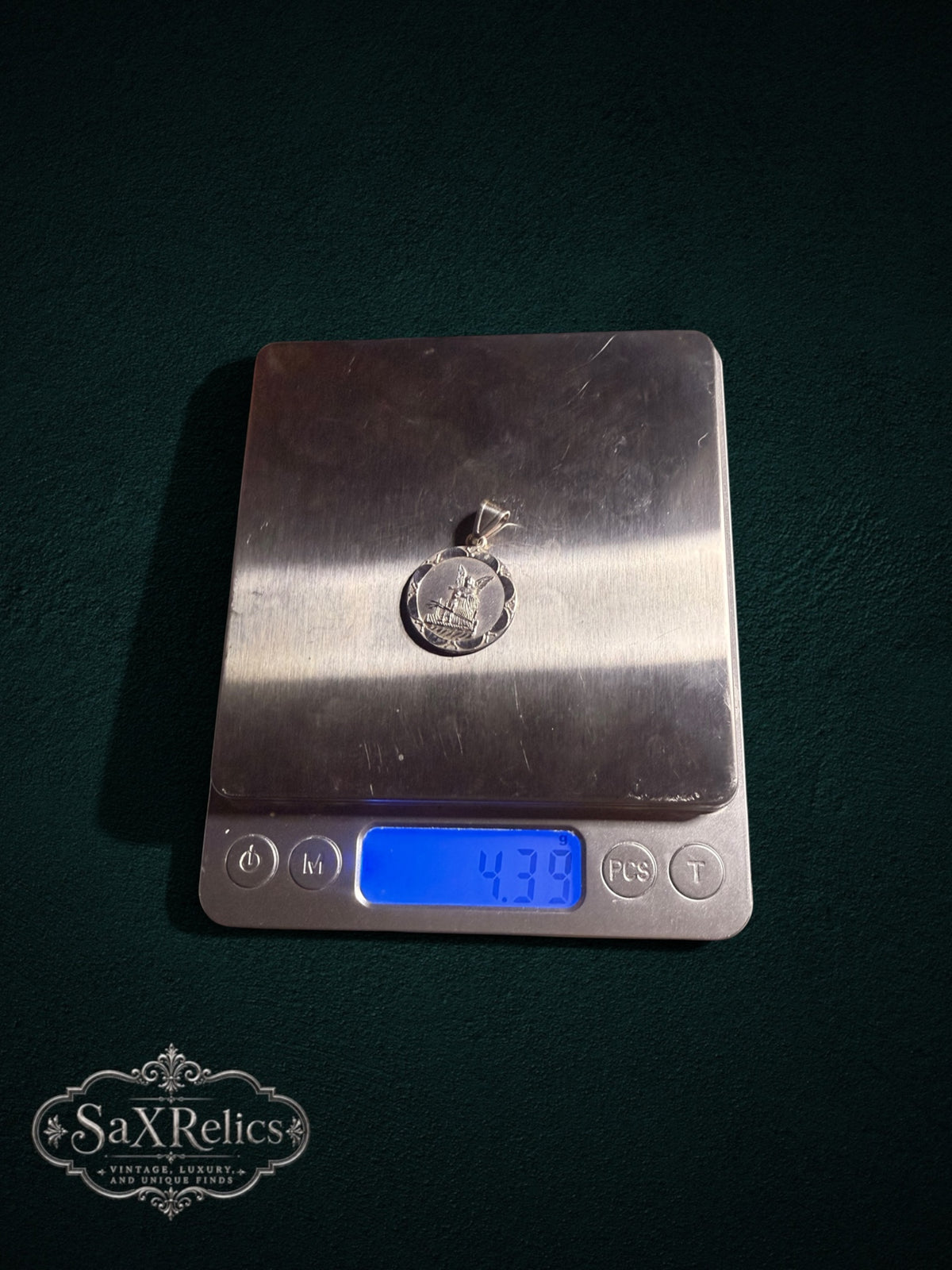 Custodio sterling silver Guardian Angel medallion on a digital scale, 4.39 g