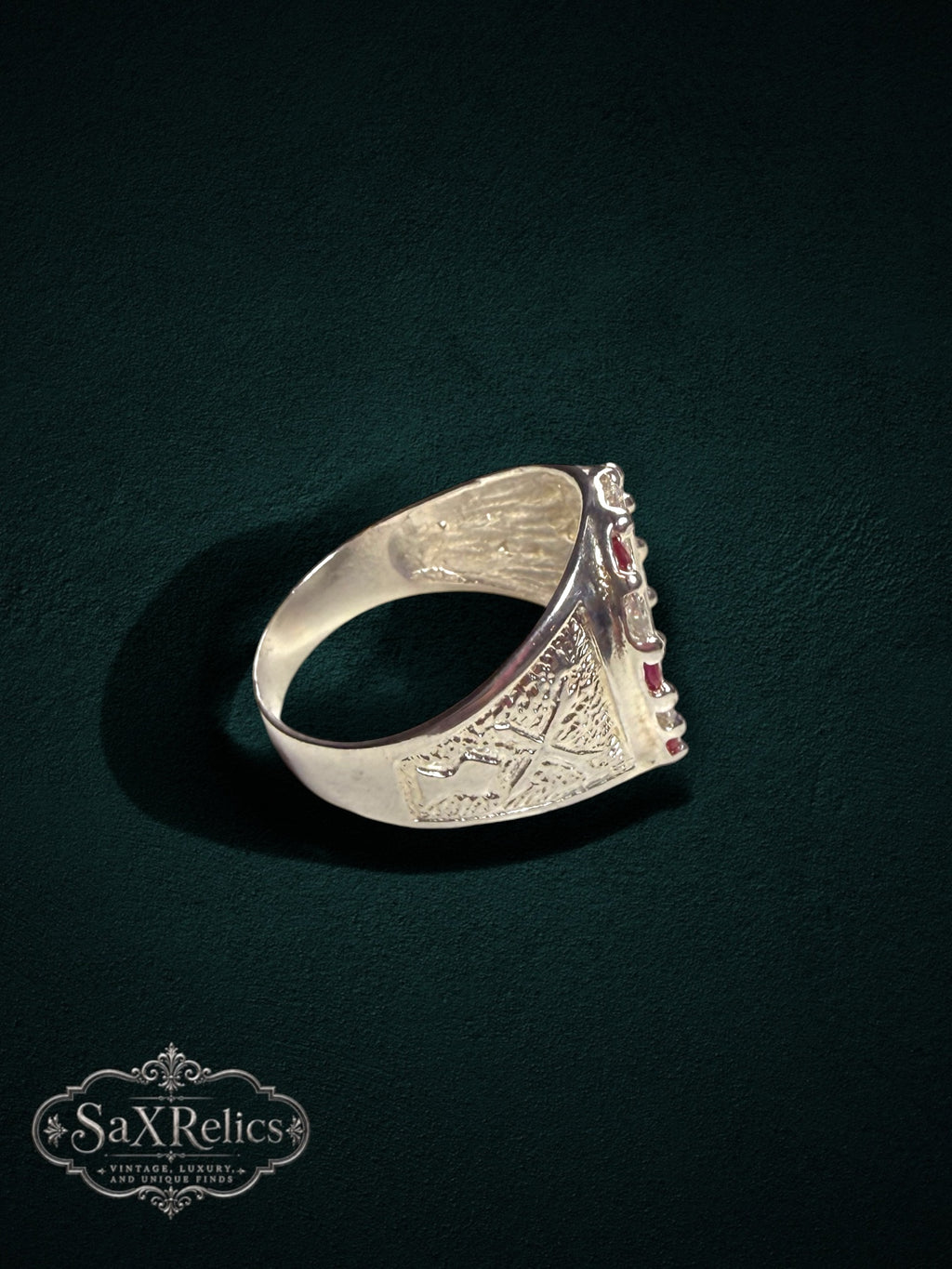 My Store sterling silver horseshoe statement ring with red rubies and clear stones featuring intricate side detailing.