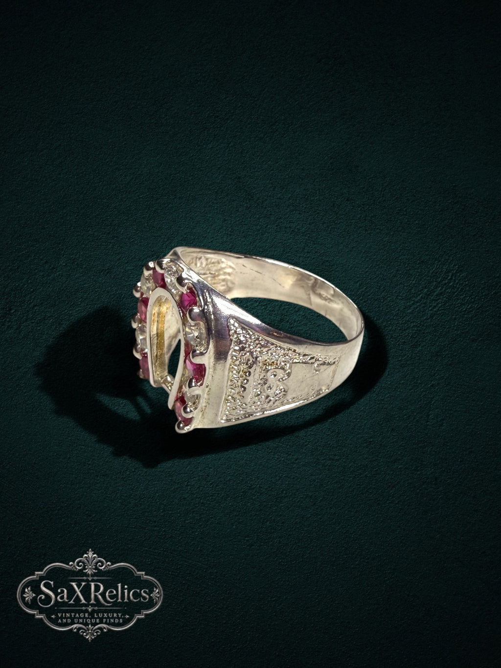 My Store sterling silver horseshoe statement ring featuring red rubies and intricate textured side detailing.