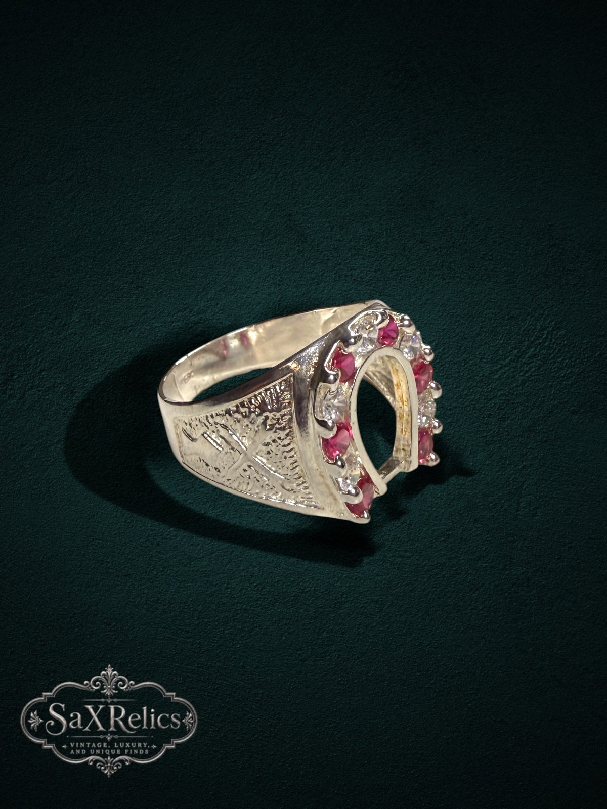 My Store sterling silver horseshoe statement ring featuring red rubies and clear stones with intricate side detailing.