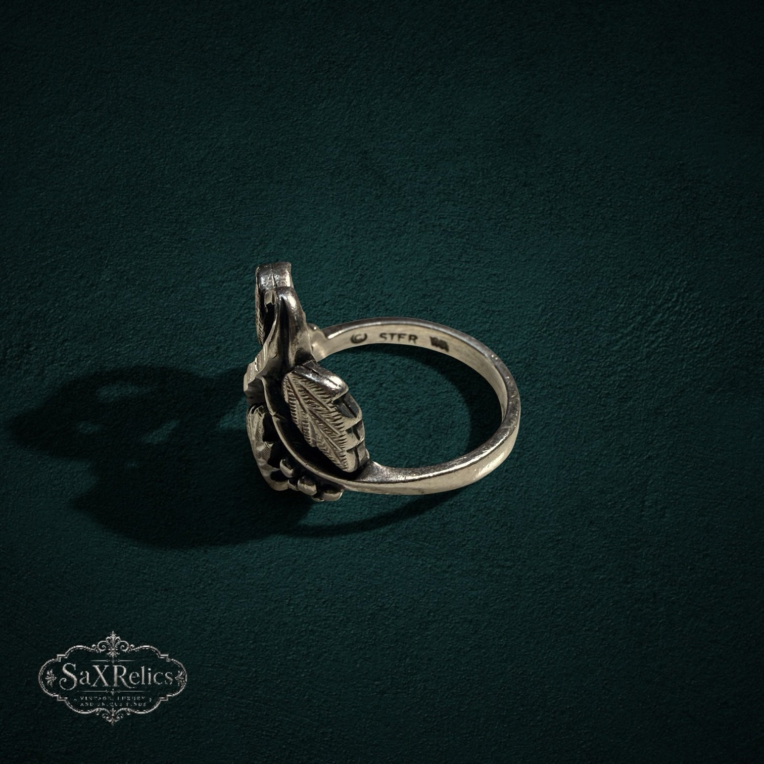 My Store SAXRelics sterling silver ring featuring an intricate botanical leaf and berry design with oxidized finish.
