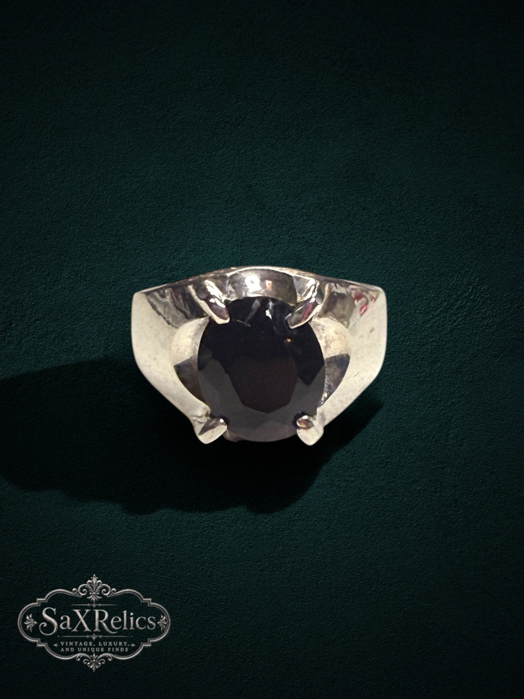 My Store SAXRelics sterling silver statement ring featuring a dark oval-cut gemstone in a robust four-prong setting.