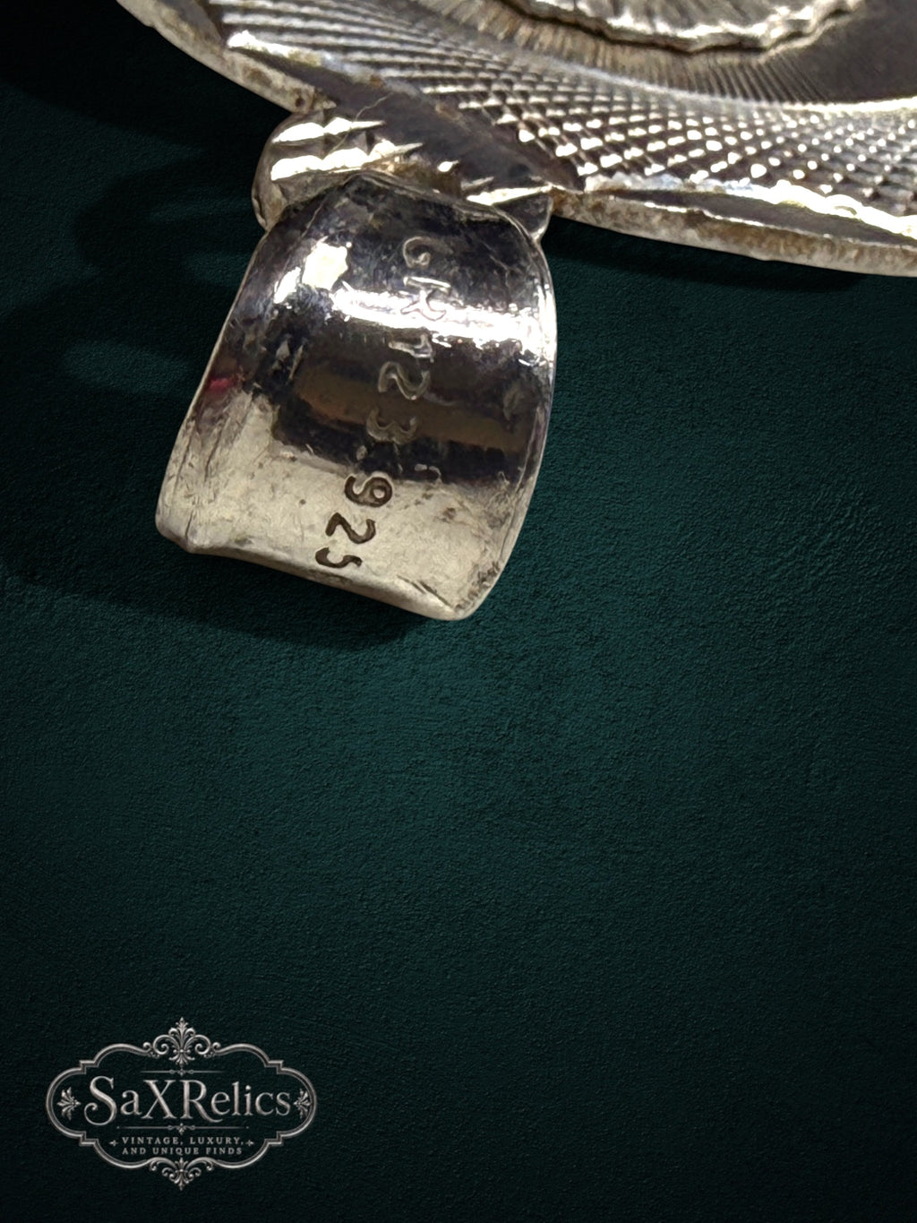 My Store 925 sterling silver religious pendant bail with hallmark detail on a dark green background