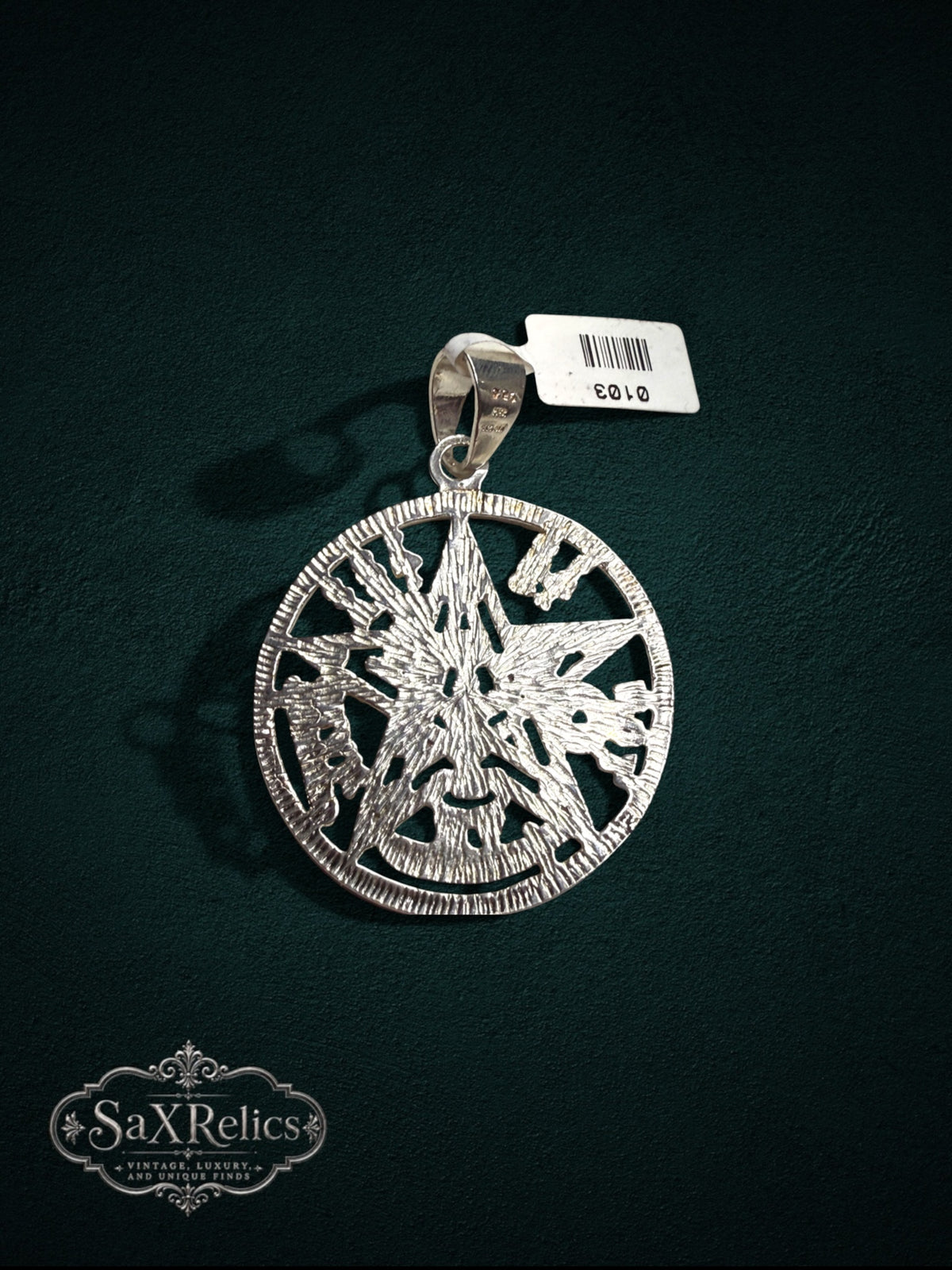 My Store sterling silver pentacle medallion pendant with intricate engraved star design on a dark background