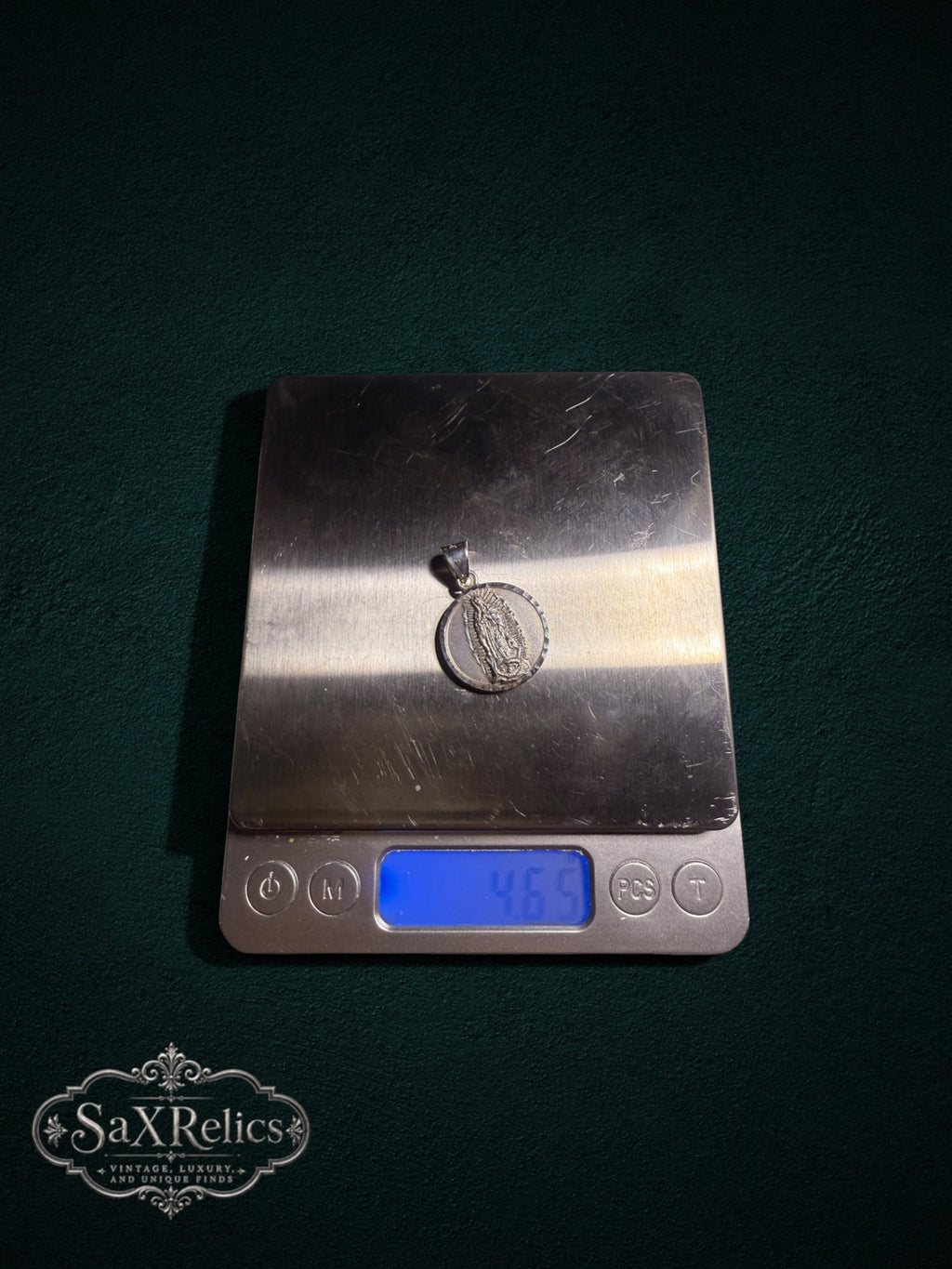 Milagro sterling silver medallion on a digital scale, 4.65 g
