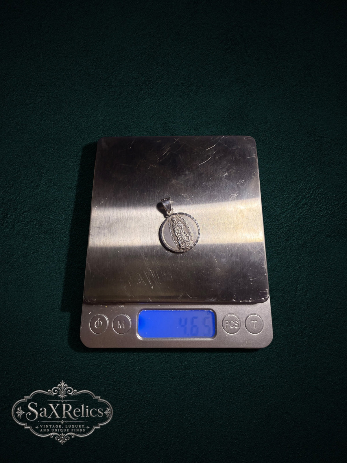 Milagro sterling silver medallion on a digital scale, 4.65 g