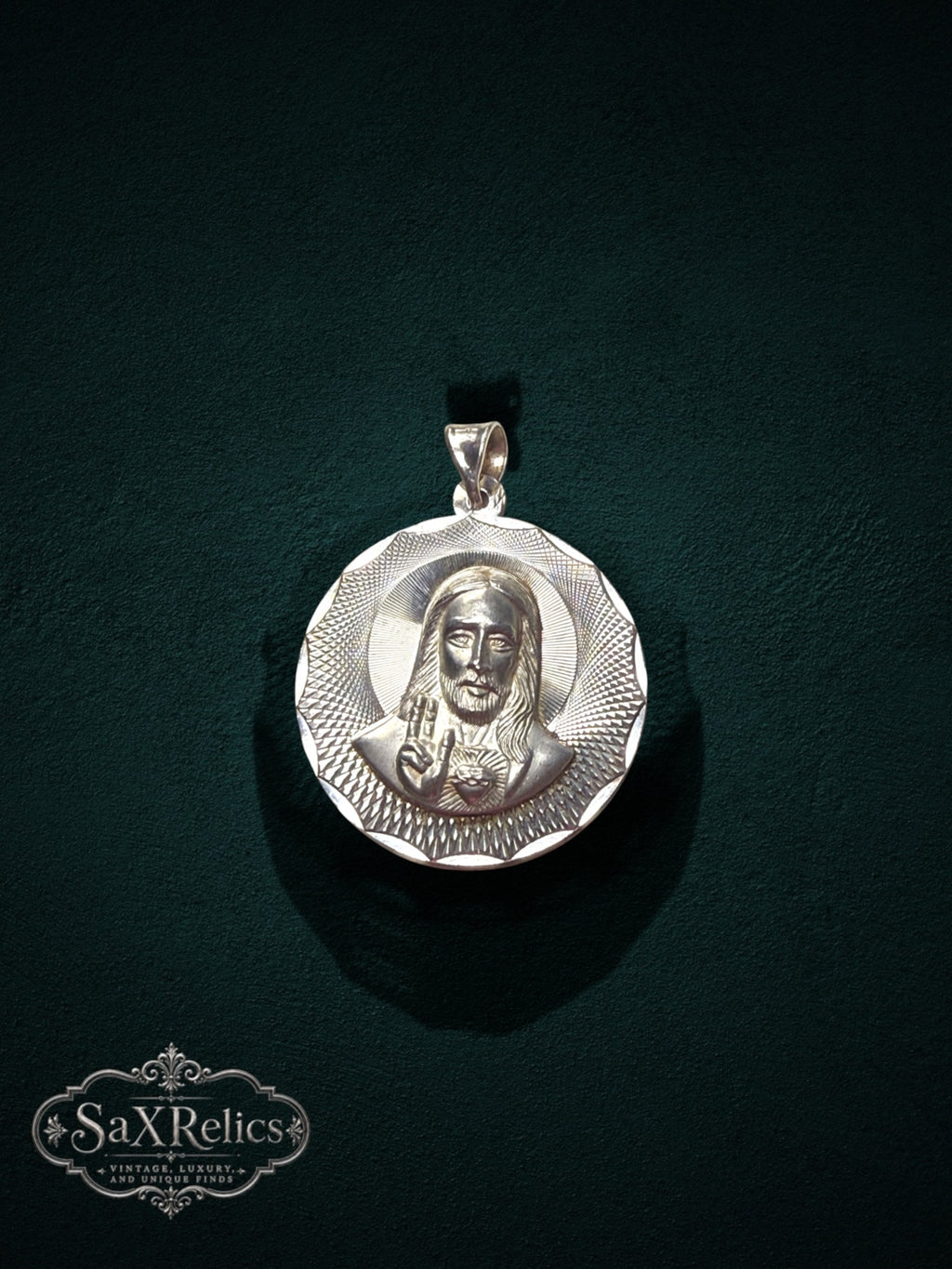 My Store 925 sterling silver Sacred Heart of Jesus pendant with sunburst textured border on a dark green background.
