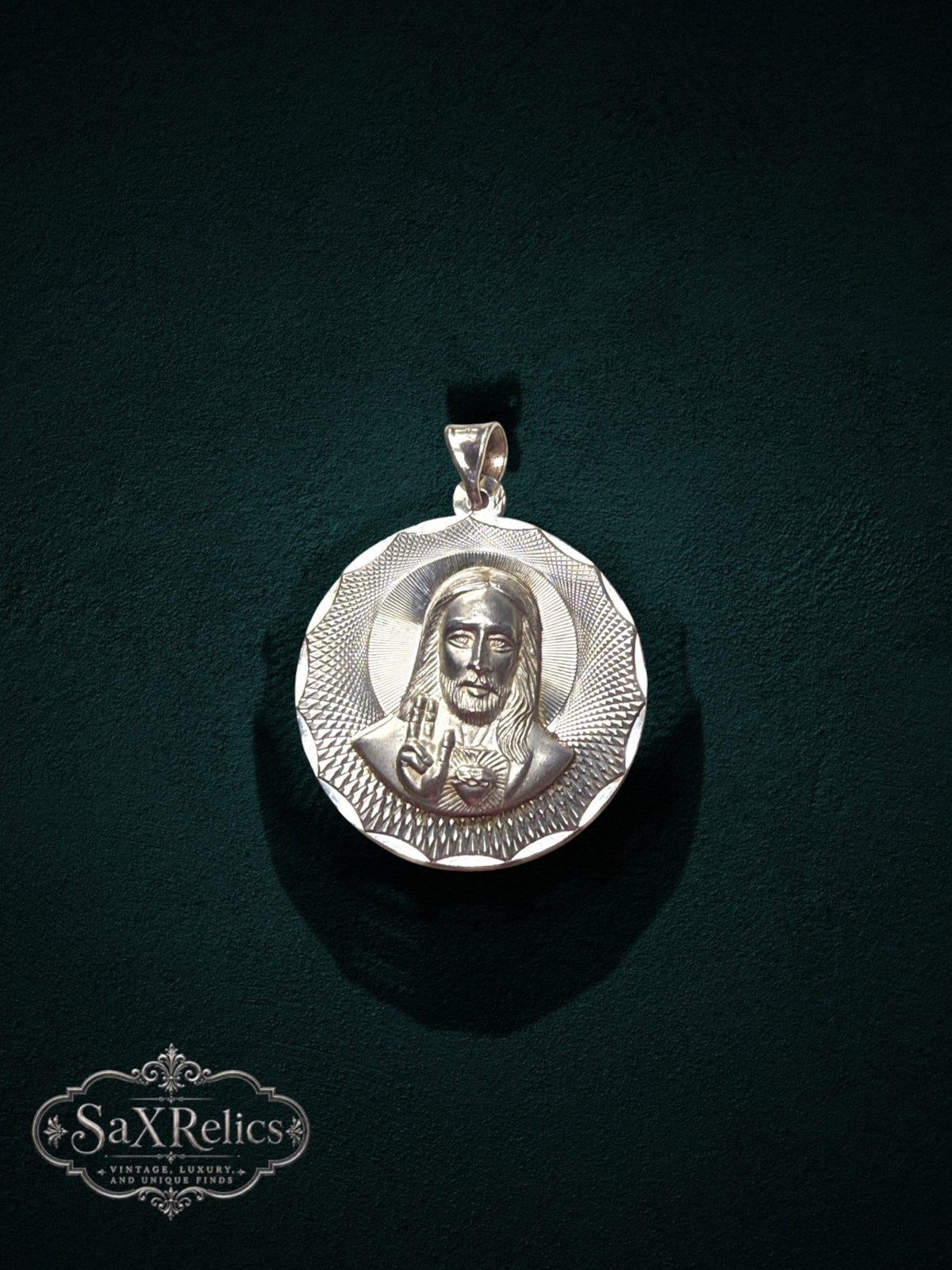 My Store 925 sterling silver Sacred Heart of Jesus pendant with sunburst textured border on a dark green background.