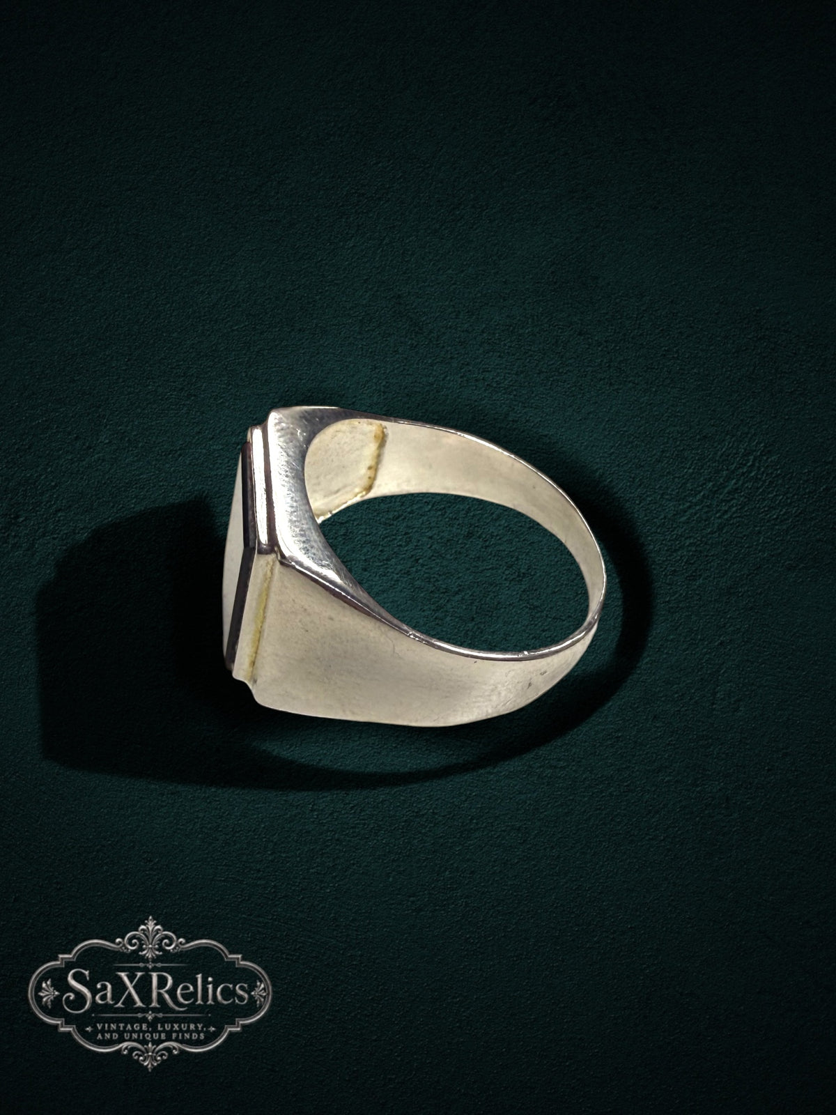My Store sterling silver rectangular signet ring with a smooth inlay on a dark textured background