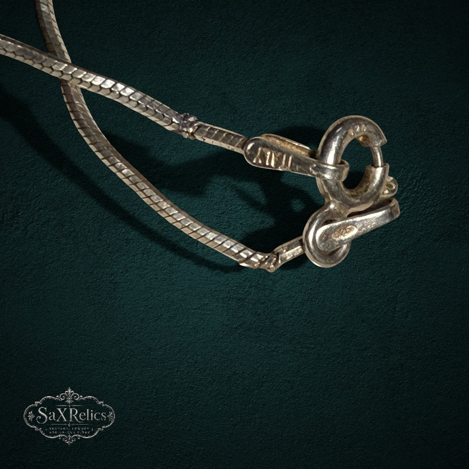My Store 925 sterling silver snake chain necklace with Italian hallmark clasp detail on a dark green background