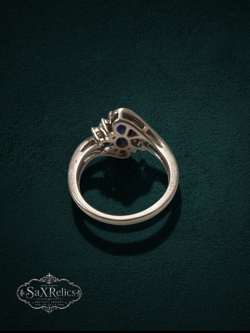 My Store sterling silver statement ring with blue stones and clear crystals, shown from a side profile view.