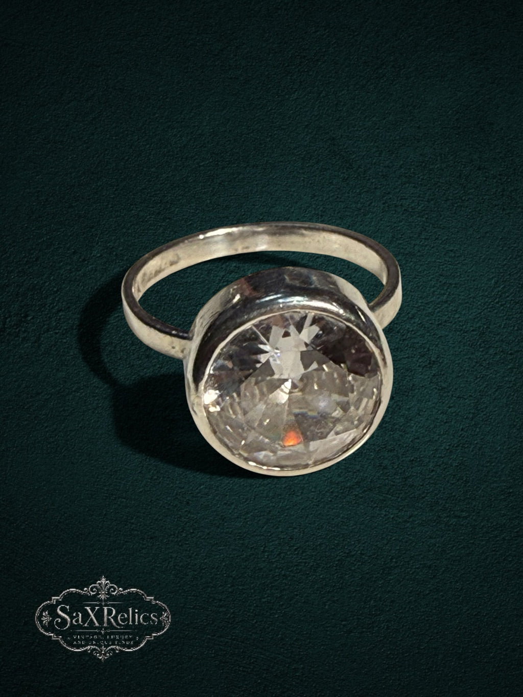 My Store SAXRelics sterling silver statement ring featuring a large brilliant-cut clear stone in a bezel setting.